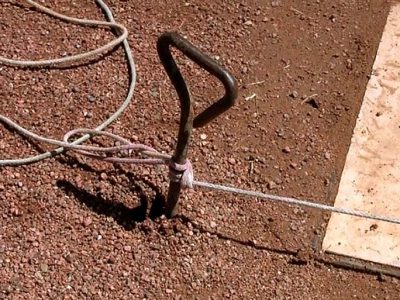 Photo: Pin in the ground with string tied to it